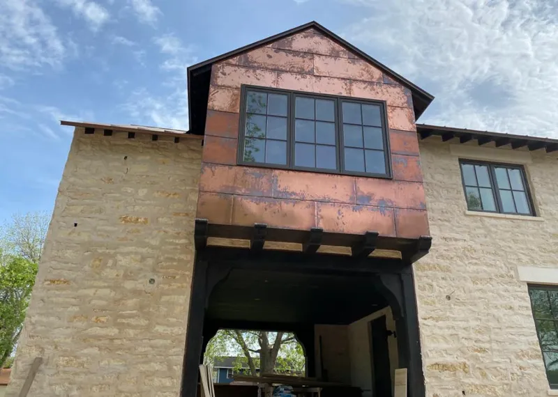 Copper metal panel facade on a stone building for Skylight Installation in Tooele